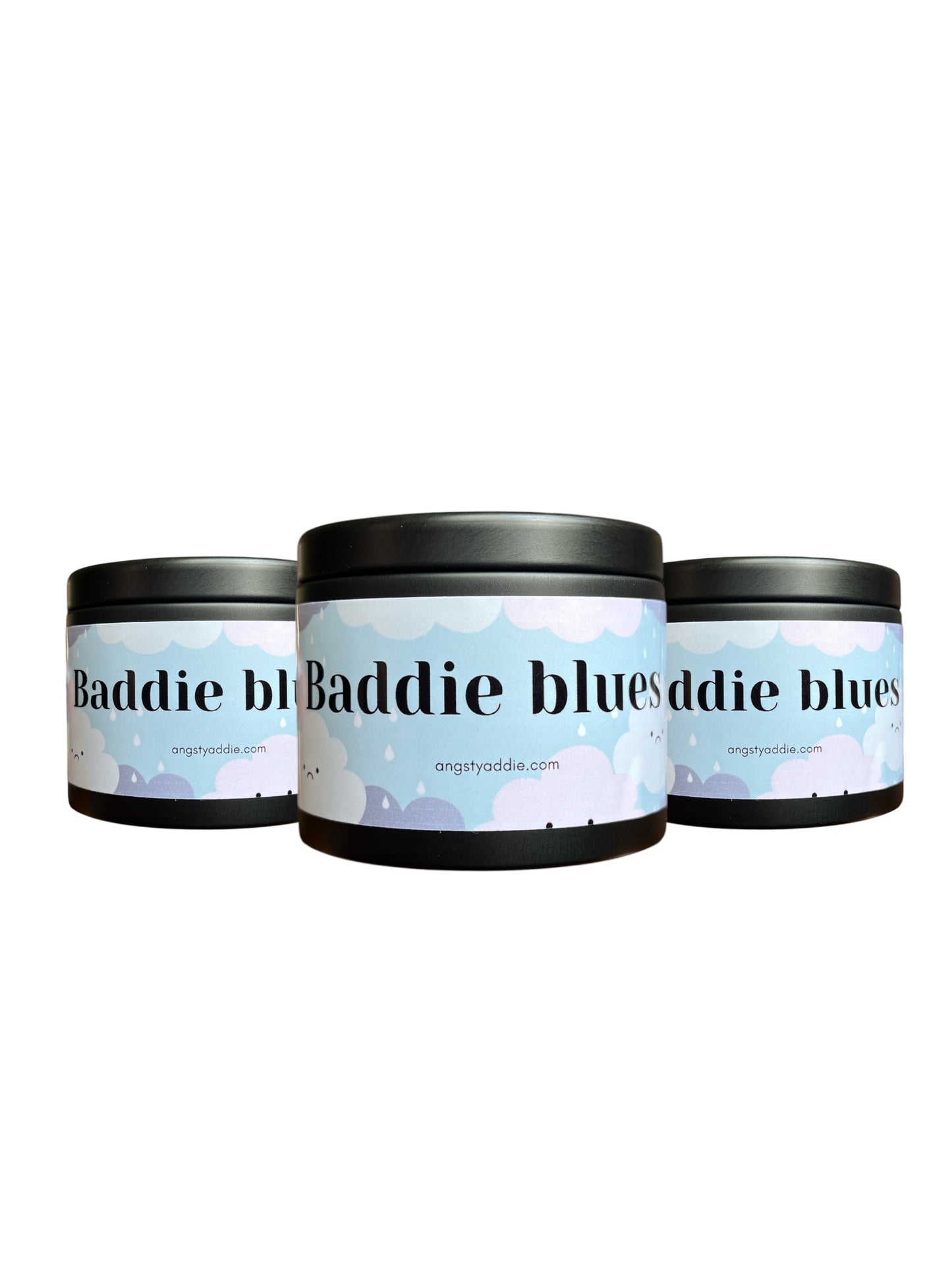 Three cylindrical containers with a label that reads "Baddie Baddie blues" and a website address "angstyaddie.com".
