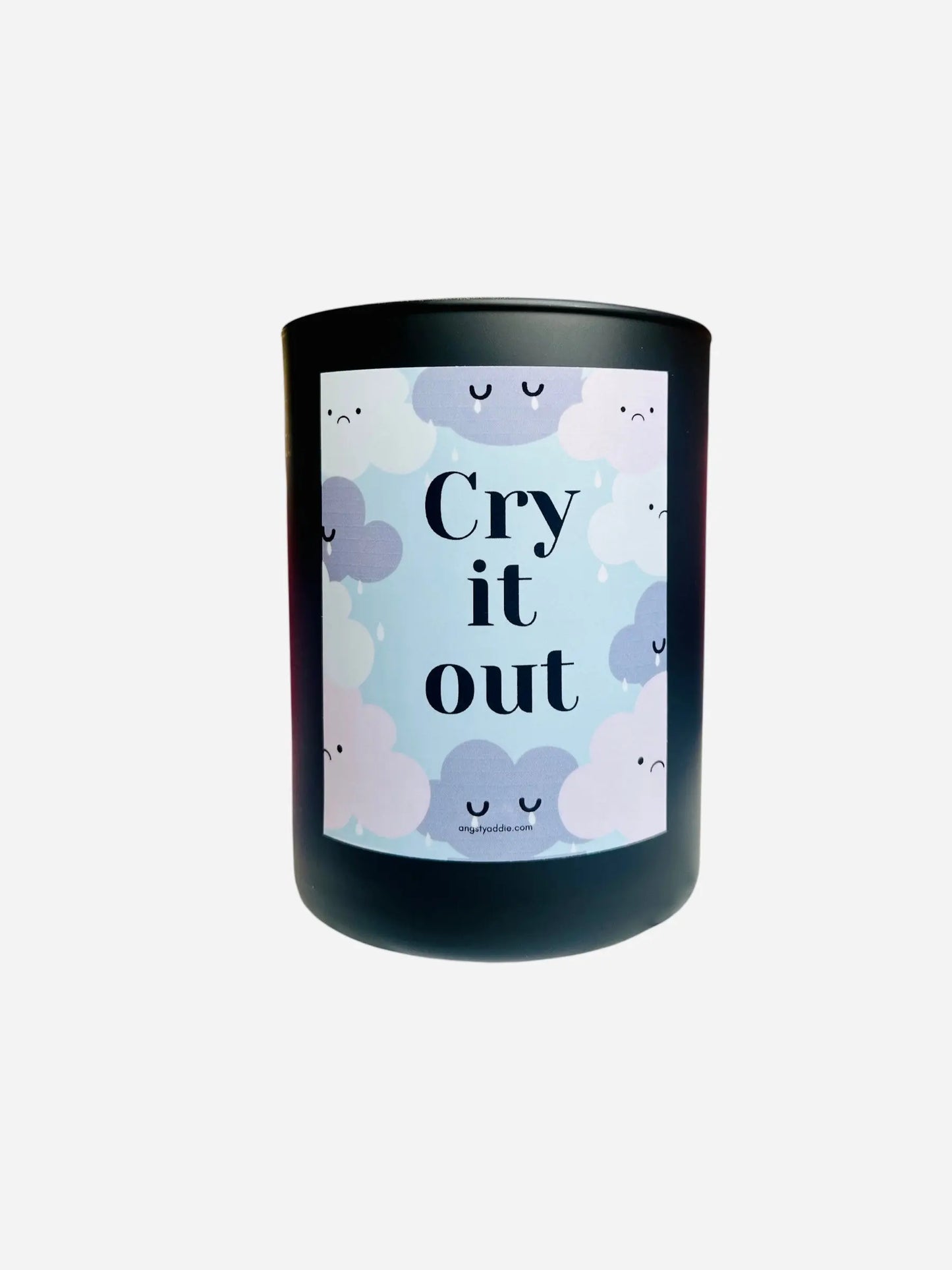 Candle with a label featuring clouds and the text 'Cry it out' on a white background