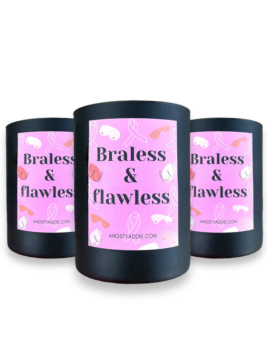 Three black "Braless & flawless" candles with pink ribbon-print labels on a white background