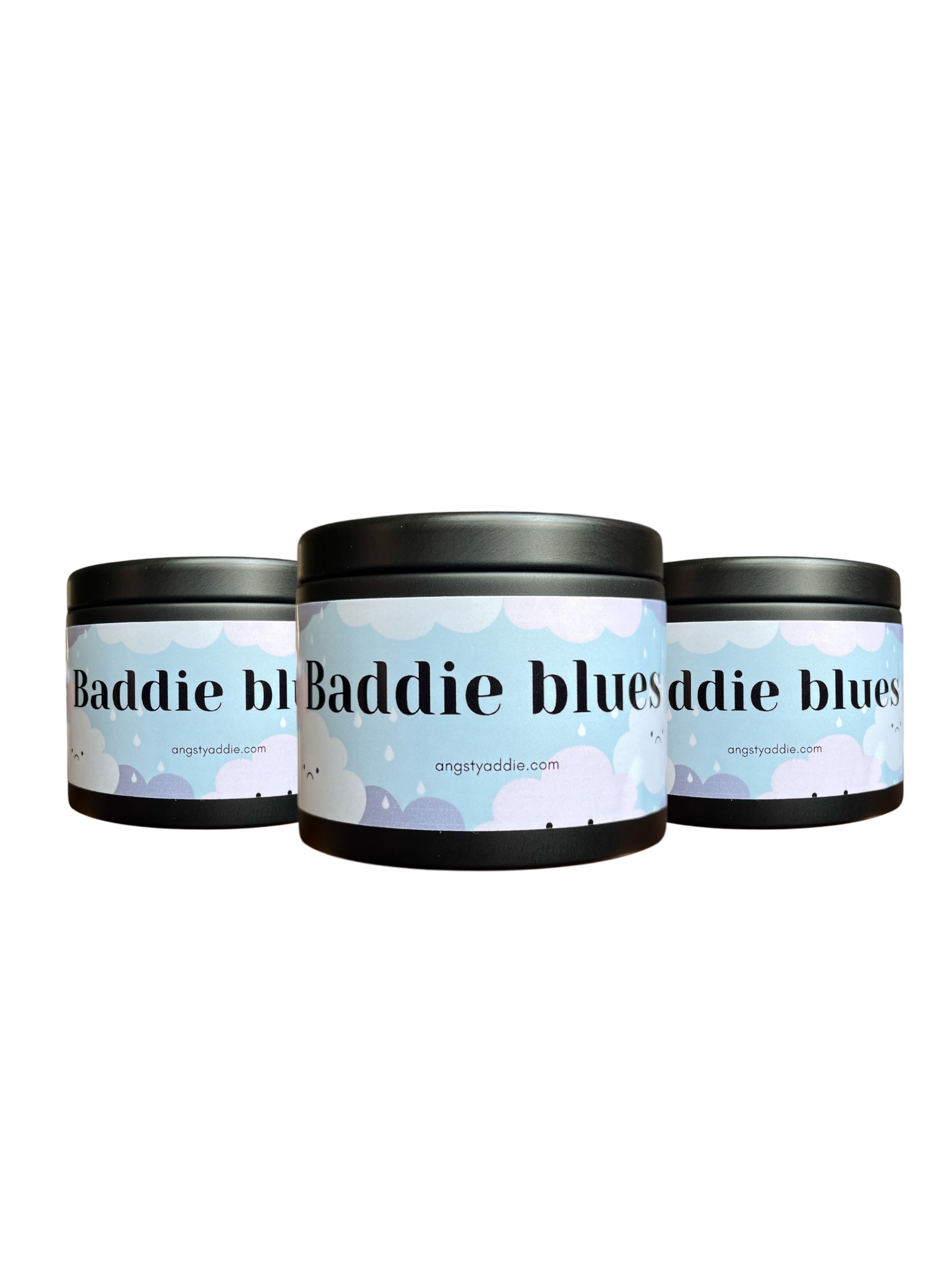 Three cylindrical containers with a label that reads "Baddie Baddie blues" and a website address "angstyaddie.com".