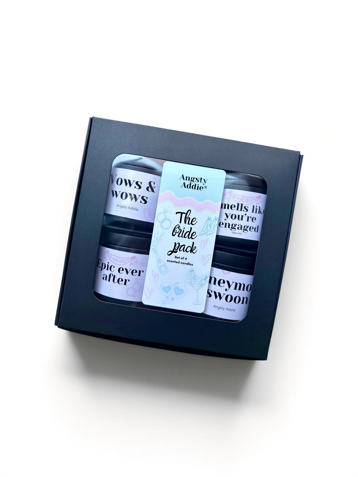 A black box containing three small jars with text on them, placed on a white background.