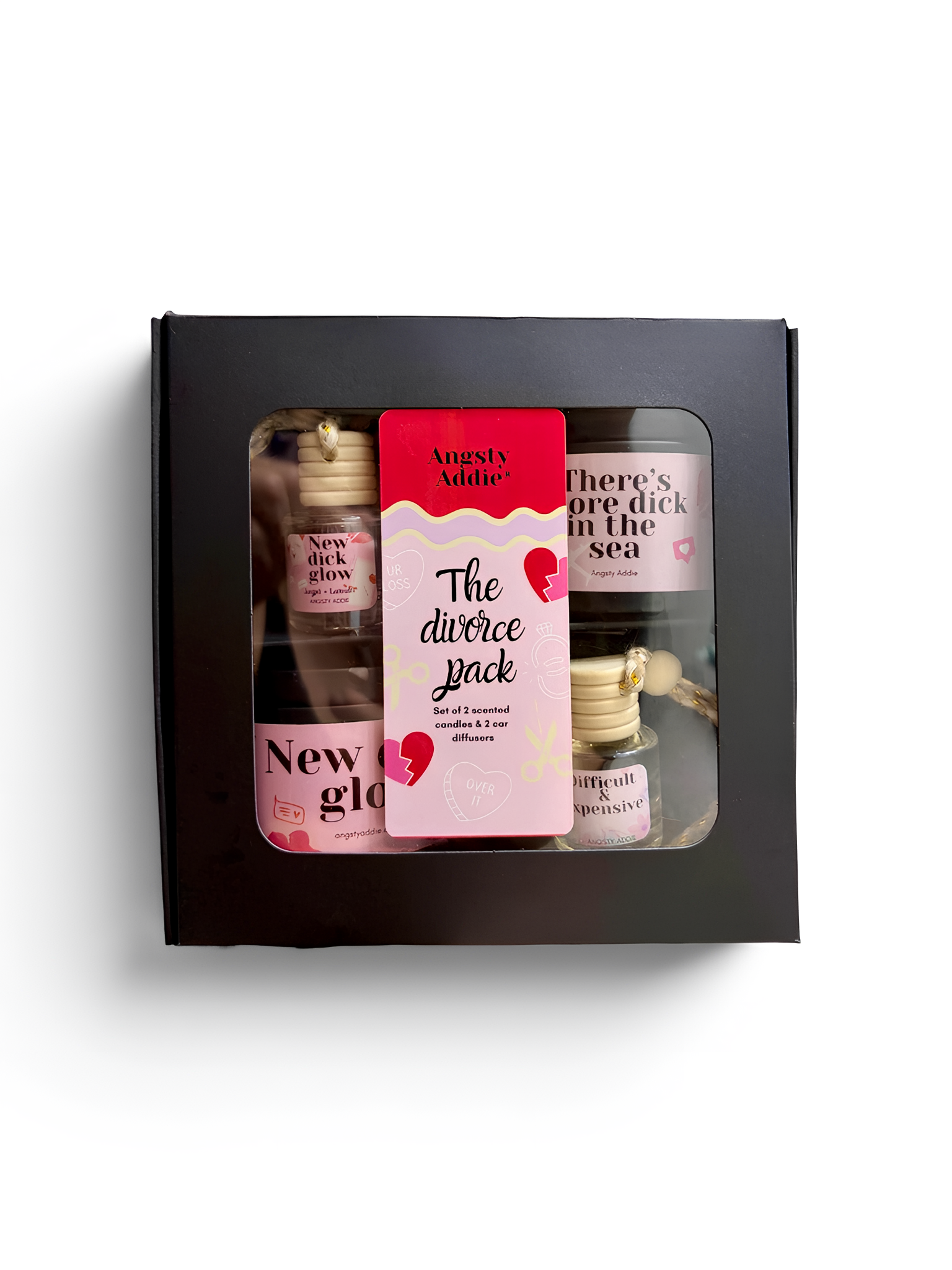 a set of three small bottles, each with a unique label, arranged in a black box.