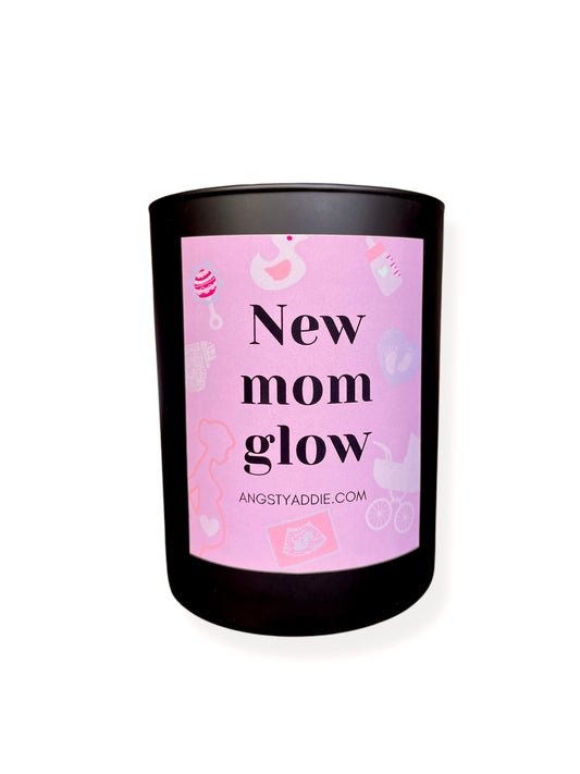 a pink candle with the words new mom glow on it